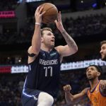 Dallas Mavericks guard Luka Doncic (77) leaps to shoot as Phoenix Suns' Cameron Payne, center, and Mavericks' Maxi Kleber, right, look on in the second half of Game 4 of an NBA basketball second-round playoff series, Sunday, May 8, 2022, in Dallas. (AP Photo/Tony Gutierrez)