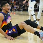 Phoenix Suns guard Devin Booker (1) looks for a foul call against the Dallas Mavericks during the first half of Game 7 of an NBA basketball Western Conference playoff semifinal, Sunday, May 15, 2022, in Phoenix. (AP Photo/Matt York)