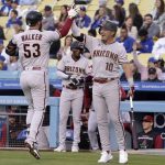Arizona Diamondbacks' Christian Walker, left, celebrates with Josh Rojas after hitting a solo home run during the first inning of a baseball game against the Los Angeles Dodgers Tuesday, May 17, 2022, in Los Angeles. (AP Photo/Mark J. Terrill)