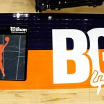 A floor decal in front of the scorer's table pays tribute to Brittney Griner before a WNBA basketball game between the Mercury and the Las Vegas Aces, Friday, May 6, 2022, in Phoenix. Griner has been detained in Russia since Feb. 17 after authorities at the Moscow airport said they found vape cartridges that allegedly contained oil derived from cannabis in her luggage. (AP Photo/Darryl Webb)
