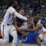 Dallas Mavericks guard Jalen Brunson, center, drives to the basket against Phoenix Suns forward Jae Crowder, left, and Phoenix Suns guard Chris Paul, right, during the second half of Game 6 of an NBA basketball second-round playoff series, Thursday, May 12, 2022, in Dallas. (AP Photo/Tony Gutierrez)