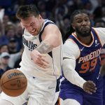 Dallas Mavericks guard Luka Doncic, left, and Phoenix Suns forward Jae Crowder (99) battle for a loose ball during the second half of Game 3 of an NBA basketball second-round playoff series, Friday, May 6, 2022, in Dallas. (AP Photo/Tony Gutierrez)