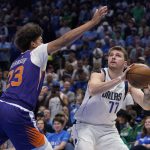 Dallas Mavericks guard Luka Doncic (77) looks to shoot against Phoenix Suns forward Cameron Johnson (23) during the second half of Game 3 of an NBA basketball second-round playoff series, Friday, May 6, 2022, in Dallas. (AP Photo/Tony Gutierrez)