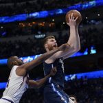 Dallas Mavericks forward Davis Bertans, right, is fouled by Phoenix Suns guard Chris Paul, left, as he drives to the basket during the second half of Game 6 of an NBA basketball second-round playoff series, Thursday, May 12, 2022, in Dallas. (AP Photo/Tony Gutierrez)