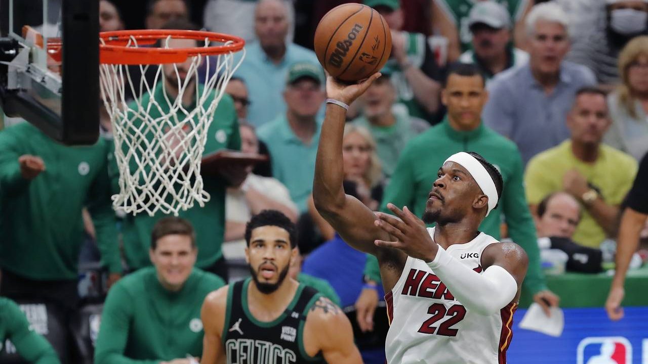 Miami Heat's Jimmy Butler (22) shoots against Boston Celtics' Jayson Tatum (0) during the second ha...