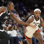 Las Vegas Aces' Jackie Young (0) dribbles past Phoenix Mercury's Tina Charles (31) during the second half of a WNBA basketball game Friday, May 6, 2022, in Phoenix. (AP Photo/Darryl Webb)