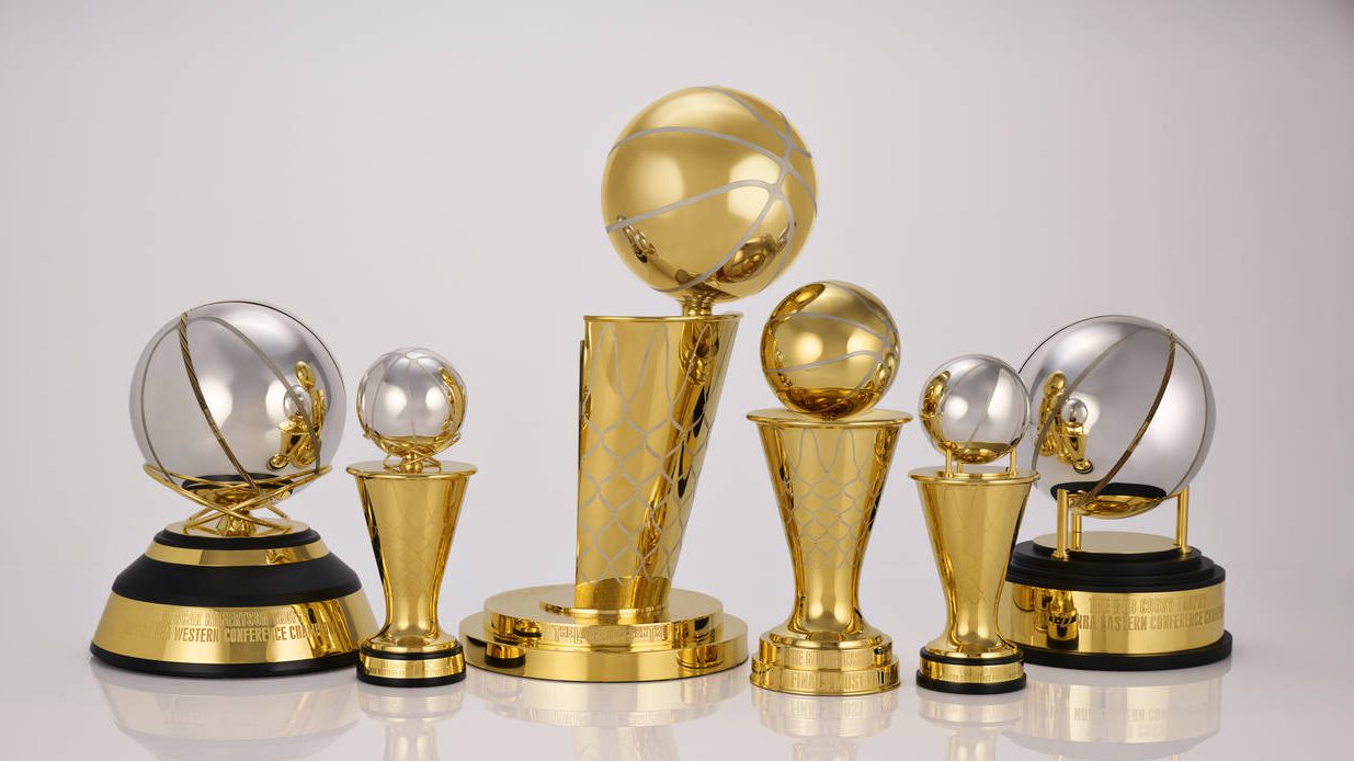 This photo provided by the NBA shows a group of trophies. The NBA's championship trophy has a new l...