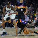 Dallas Mavericks forward Reggie Bullock (25) and Phoenix Suns guard Cameron Payne (15) scramble for a loose ball during the first half of Game 2 in the second round of the NBA Western Conference playoff series Wednesday, May 4, 2022, in Phoenix. (AP Photo/Matt York)