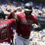 
              Arizona Diamondbacks' Christian Walker, right, celebrates his two-run home run Cooper Hummel (21) during the third inning of the first game of a baseball double-header against the Los Angeles Dodgers Tuesday, May 17, 2022, in Los Angeles. (AP Photo/Marcio Jose Sanchez)
            