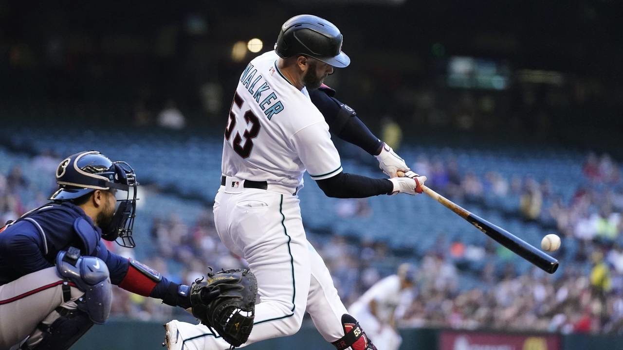 Arizona Diamondbacks' Christian Walker (53) connects for a two-run home run as Atlanta Braves catch...