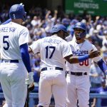 Los Angeles Dodgers' Mookie Betts, right, celebrates his two-run home run with Hanser Alberto (17) and Freddie Freeman (5) during the sixth inning of a baseball game against the Arizona Diamondbacks Tuesday, May 17, 2022, in Los Angeles. (AP Photo/Marcio Jose Sanchez)