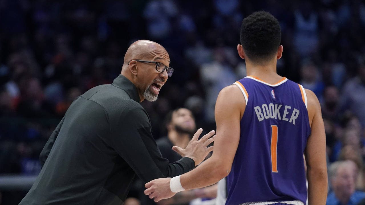 Phoenix Suns head coach Monty Williams, left, talks with guard Devin Booker (1) during the second h...