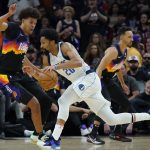 Phoenix Suns forward Cameron Johnson (23) defends against Dallas Mavericks guard Spencer Dinwiddie during the first half of Game 7 of an NBA basketball Western Conference playoff semifinal, Sunday, May 15, 2022, in Phoenix. (AP Photo/Matt York)