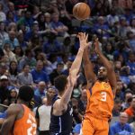 Dallas Mavericks center Dwight Powell, center, defends as Phoenix Suns guard Chris Paul (3) shoots in the first half of Game 4 of an NBA basketball second-round playoff series, Sunday, May 8, 2022, in Dallas. (AP Photo/Tony Gutierrez)