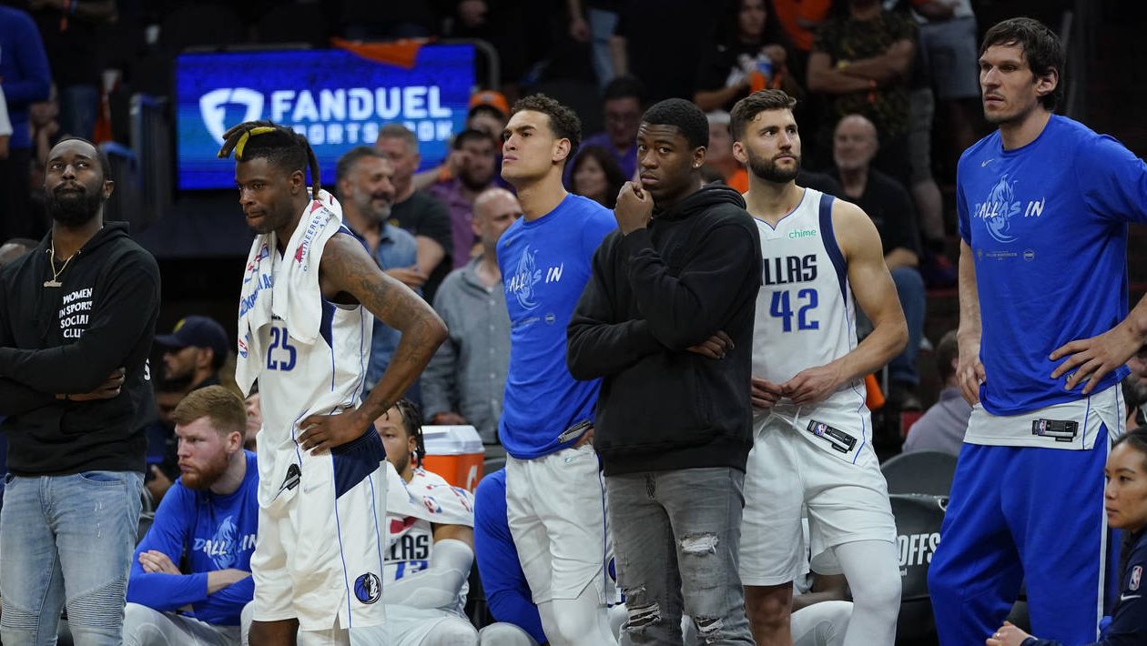 Dallas Mavericks players react during the final moments of their loss to Phoenix Suns in Game 2 of ...