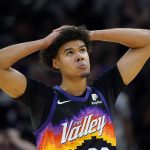 Phoenix Suns forward Cameron Johnson looks at the scoreboard during the first half of Game 7 of an NBA basketball Western Conference playoff semifinal against the Dallas Mavericks, Sunday, May 15, 2022, in Phoenix. (AP Photo/Matt York)