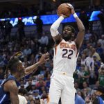 Phoenix Suns center Deandre Ayton (22) shoots over Dallas Mavericks forward Reggie Bullock, left, during the first half of Game 6 of an NBA basketball second-round playoff series, Thursday, May 12, 2022, in Dallas. (AP Photo/Tony Gutierrez)