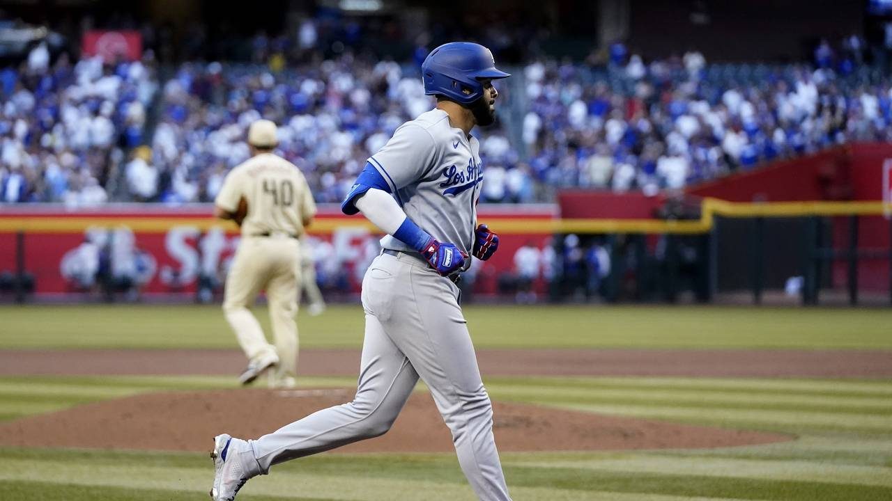 Los Angeles Dodgers' Edwin Rios, foreground, rounds the bases after hitting a three-run home run ag...