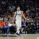Dallas Mavericks guard Luka Doncic (77) smiles after making a basket against the Phoenix Suns during the second half of Game 7 of an NBA basketball Western Conference playoff semifinal, Sunday, May 15, 2022, in Phoenix. The Mavericks defeated the Suns 123-90. (AP Photo/Matt York)