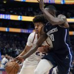 Phoenix Suns forward Cameron Johnson (23) collides with Dallas Mavericks forward Dorian Finney-Smith (10) as he drives with the ball during the first half of Game 6 of an NBA basketball second-round playoff series, Thursday, May 12, 2022, in Dallas. (AP Photo/Tony Gutierrez)
