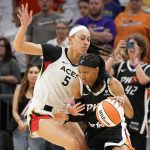 
              Phoenix Mercury's Shey Peddy, front right, drives around Las Vegas Aces' Dearica Hamby (5) during the first half of a WNBA basketball game Friday, May 6, 2022, in Phoenix. (AP Photo/Darryl Webb)
            