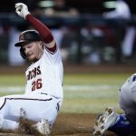 Arizona Diamondbacks' Pavin Smith scores a run against the Kansas City Royals during the fourth inning of a baseball game Monday, May 23, 2022, in Phoenix. (AP Photo/Ross D. Franklin)