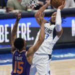 Dallas Mavericks guard Jalen Brunson (13) drives to the basket against Phoenix Suns guard Cameron Payne (15) during the second half of Game 3 of an NBA basketball second-round playoff series, Friday, May 6, 2022, in Dallas. (AP Photo/Tony Gutierrez)