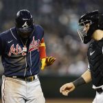 After being hit by a pitch, Atlanta Braves' Ronald Acuna Jr., left, slaps the hand of Arizona Diamondbacks catcher Daulton Varsho, right, away during the fifth inning of a baseball game Tuesday, May 31, 2022, in Phoenix. (AP Photo/Ross D. Franklin)