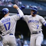 Kansas City Royals' Bobby Witt Jr. (7) celebrates his home run against the Arizona Diamondbacks with teammate Hunter Dozier (17) during the first inning of a baseball game Monday, May 23, 2022, in Phoenix. (AP Photo/Ross D. Franklin)