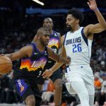 Phoenix Suns guard Chris Paul (3) drives to the basket against Dallas Mavericks guard Spencer Dinwiddie (26) during the second half of Game 2 of an NBA basketball second-round playoff series, Wednesday, May 4, 2022, in Phoenix. (AP Photo/Matt York)