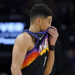 Phoenix Suns guard Devin Booker looks towards his bench during the second half of Game 7 of an NBA basketball Western Conference playoff semifinal against the Dallas Mavericks, Sunday, May 15, 2022, in Phoenix. The Mavericks defeated the Suns 123-90. (AP Photo/Matt York)