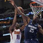 Phoenix Suns center Bismack Biyombo (18) drives to the basket against Dallas Mavericks forward Reggie Bullock (25) during the first half of Game 6 of an NBA basketball second-round playoff series, Thursday, May 12, 2022, in Dallas. (AP Photo/Tony Gutierrez)