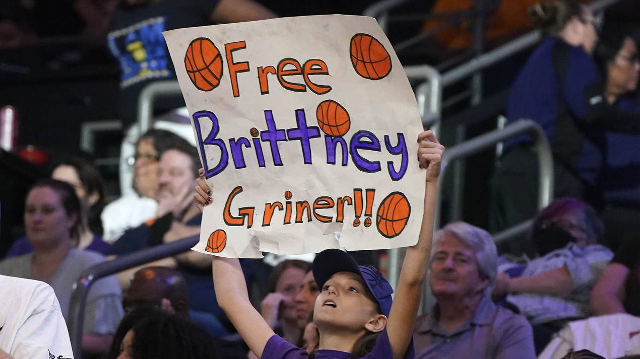 A young Phoenix Mercury fan holds up a sign "Free Brittney Griner" during a WNBA basketball game ag...