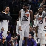Phoenix Suns guard Devin Booker, left, Deandre Ayton, center, and Jae Crowder (99) stand near the bench during the final moments of the second half of Game 6 of an NBA basketball second-round playoff series against the Dallas Mavericks, Thursday, May 12, 2022, in Dallas. (AP Photo/Tony Gutierrez)