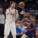 Dallas Mavericks guard Luka Doncic (77) passes the ball past Phoenix Suns forward Mikal Bridges (25) during the first half of Game 3 of an NBA basketball second-round playoff series, Friday, May 6, 2022, in Dallas. (AP Photo/Tony Gutierrez)