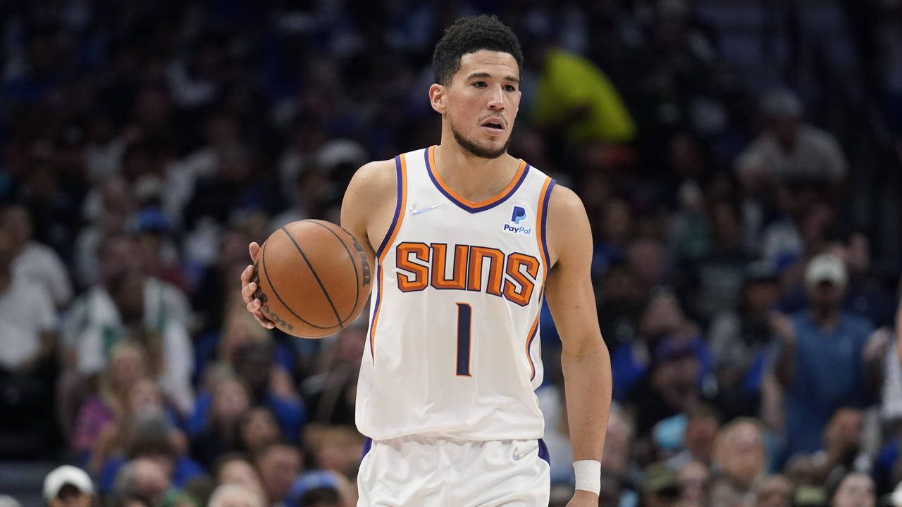 Phoenix Suns guard Devin Booker (1) moves the ball up court against the Dallas Mavericks during the...