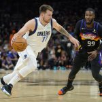 Dallas Mavericks guard Luka Doncic (77) drives as Phoenix Suns forward Jae Crowder (99) defends during the second half of Game 7 of an NBA basketball Western Conference playoff semifinal, Sunday, May 15, 2022, in Phoenix. The Mavericks defeated the Suns 123-90. (AP Photo/Matt York)