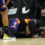 Phoenix Suns forward Jae Crowder grimaces due to an injury during the second half of Game 5 of an NBA basketball second-round playoff series against the Dallas Mavericks Tuesday, May 10, 2022, in Phoenix. The Suns won 110-80. (AP Photo/Ross D. Franklin)