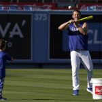 Los Angeles Dodgers pitcher Clayton Kershaw, right, is pitched to by his son Charley prior to a baseball game between the Dodgers and the Arizona Diamondbacks Tuesday, May 17, 2022, in Los Angeles. (AP Photo/Mark J. Terrill)