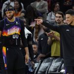Phoenix Suns center JaVale McGee (00) and Phoenix Suns guard Devin Booker, right, celebrate a play against the Dallas Mavericks during the second half of Game 2 of an NBA basketball second-round playoff series, Wednesday, May 4, 2022, in Phoenix. (AP Photo/Matt York)
