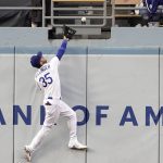 Los Angeles Dodgers center fielder Cody Bellinger can't reach a ball hit for a solo home run by Arizona Diamondbacks' Christian Walker during the first inning of a baseball game Tuesday, May 17, 2022, in Los Angeles. (AP Photo/Mark J. Terrill)