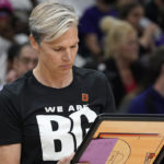 New Phoenix Mercury head coach Vanessa Nygaard wears a T-shirt referring to player Brittney Griner before a WNBA basketball game against the Las Vegas Aces, Friday, May 6, 2022, in Phoenix. Griner has been detained in Russia since Feb. 17 after authorities at the Moscow airport said they found vape cartridges that allegedly contained oil derived from cannabis in her luggage. (AP Photo/Darryl Webb)