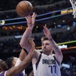 Dallas Mavericks guard Luka Doncic (77) passes the ball over Phoenix Suns guard Chris Paul, left, during the second half of Game 3 of an NBA basketball second-round playoff series, Friday, May 6, 2022, in Dallas. (AP Photo/Tony Gutierrez)