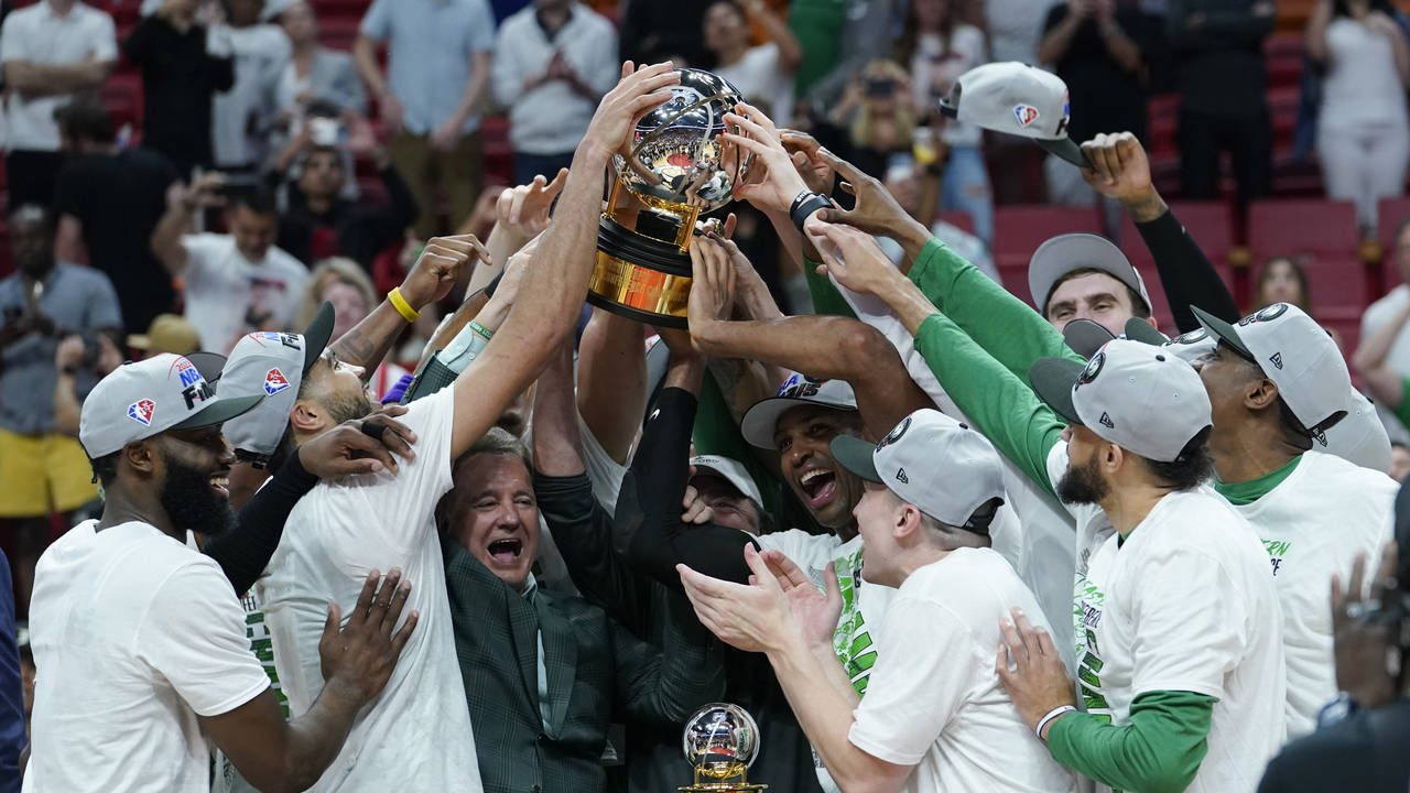 The Boston Celtics players raise the Eastern Conference trophy after defeating the Miami Heat in Ga...