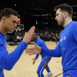 Dallas Mavericks center Dwight Powell, left, and Dallas Mavericks guard Luka Doncic, right, prepares for Game 2 in the second round of the NBA Western Conference playoff series against the Phoenix Suns, Wednesday, May 4, 2022, in Phoenix. (AP Photo/Matt York)