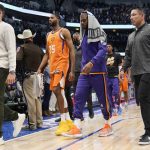 
              Phoenix Suns forward Mikal Bridges (25) and guard Chris Paul, second from right, walk off the court after Game 4 of an NBA basketball second-round playoff series against the Dallas Mavericks, Sunday, May 8, 2022, in Dallas. (AP Photo/Tony Gutierrez)
            