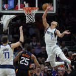 Dallas Mavericks center Dwight Powell (7) is fouled by Phoenix Suns center JaVale McGee, right, as he drives to the basket during the second half of Game 2 of an NBA basketball second-round playoff series, Wednesday, May 4, 2022, in Phoenix. (AP Photo/Matt York)
