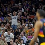 A Phoenix Suns fan watches during the second half of Game 7 of an NBA basketball Western Conference playoff semifinal against the Dallas Mavericks, Sunday, May 15, 2022, in Phoenix. The Mavericks defeated the Suns 123-90. (AP Photo/Matt York)