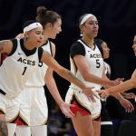 Las Vegas Aces' Kierstan Bell (1) Theresa Plaisance (55) Dearica Hambry (5) greet Kelsey Plum (10) during a timeout in the second half of the team's WNBA basketball game against the Phoenix Mercury on Friday, May 6, 2022, in Phoenix. (AP Photo/Darryl Webb)