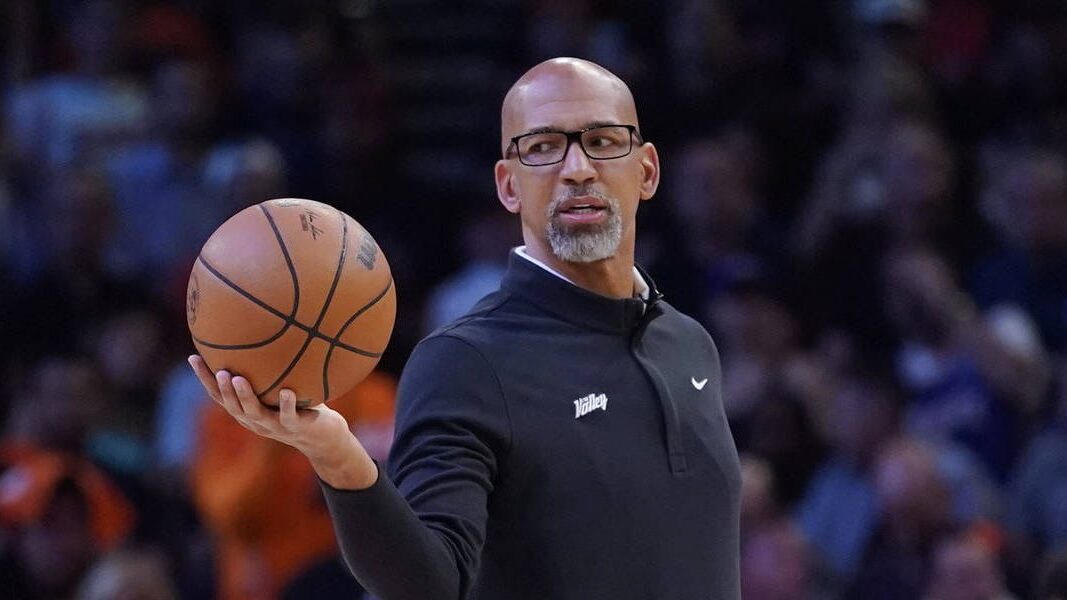 Phoenix Suns head coach Monty Williams hands off the ball during a break in the action during the f...